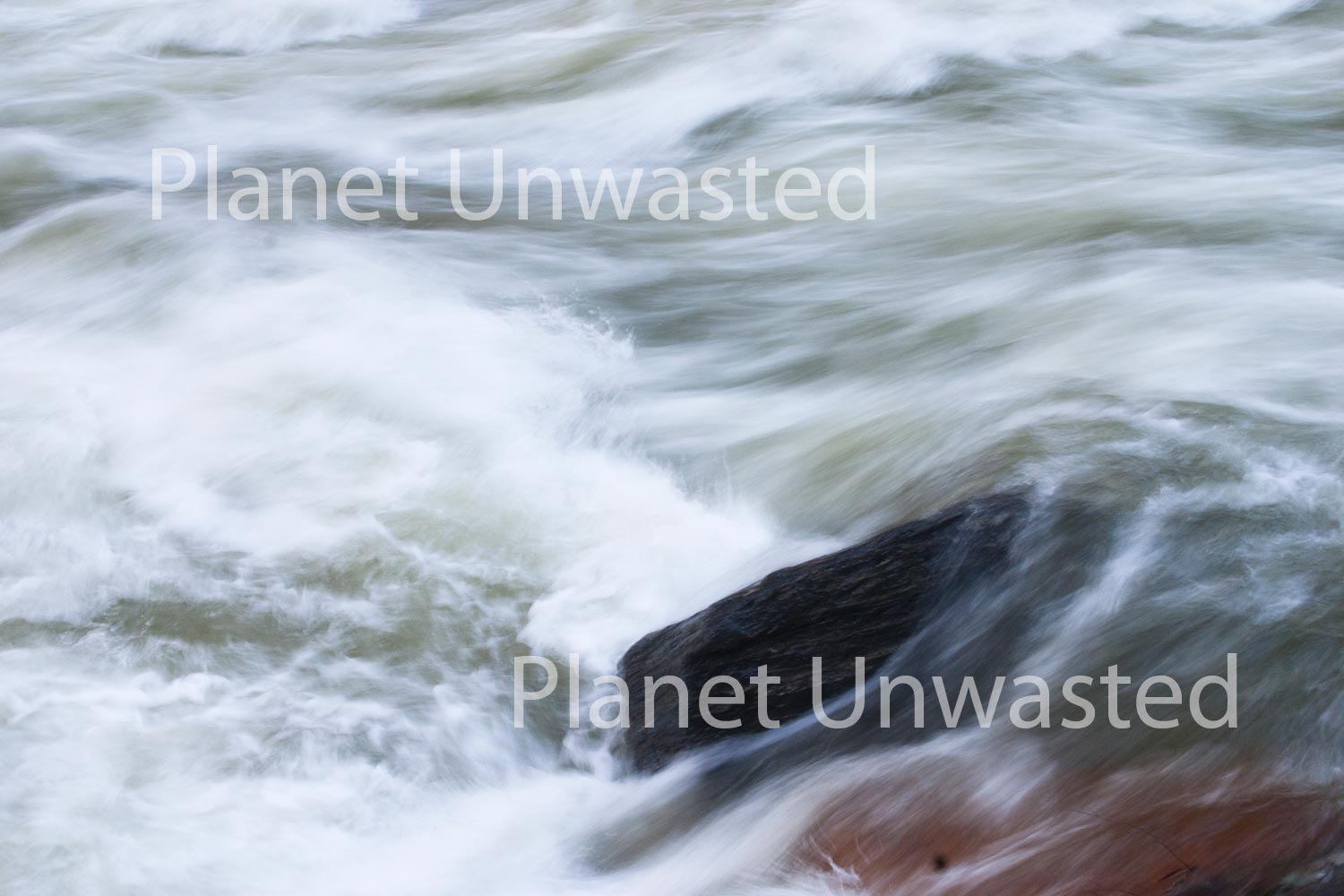 river rushes over rocks